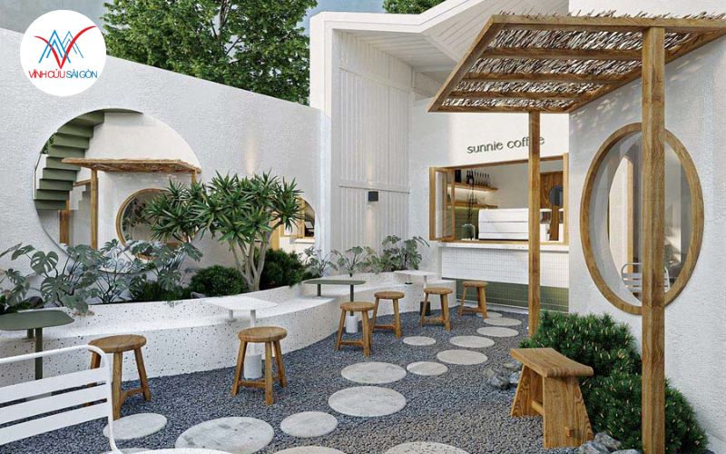 Quán cafe sân vườn có lối đi đá, sỏi và đèn trang trí